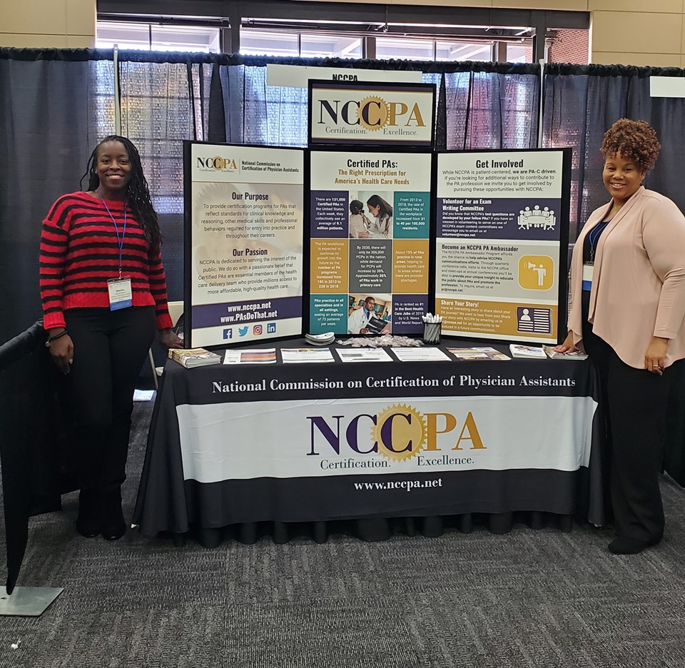 NCCPA employees at table display during conference