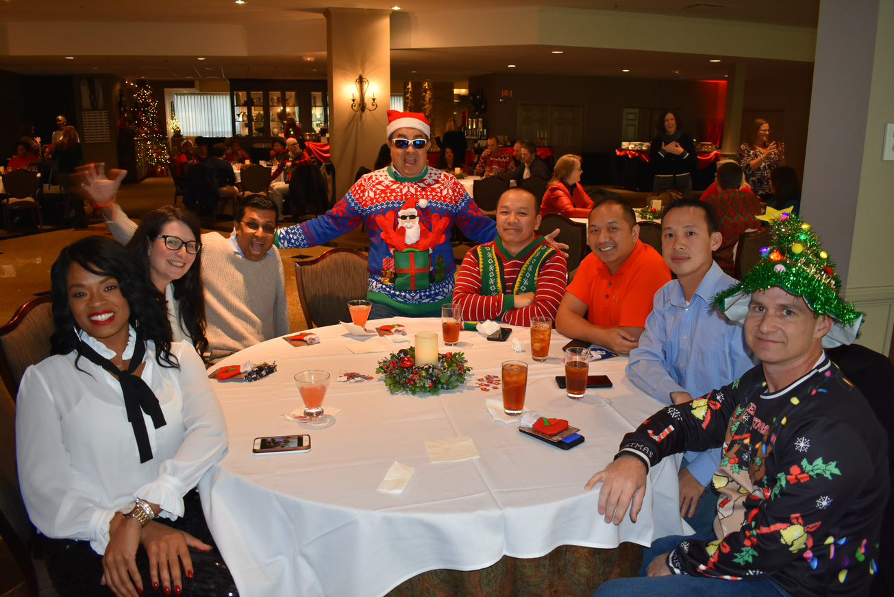 NCCPA employees sitting at table during holiday party